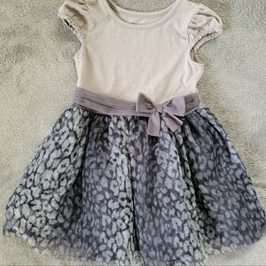 Toddler dress, leopard print base, waist bow, cotton upper with cap sleeves.